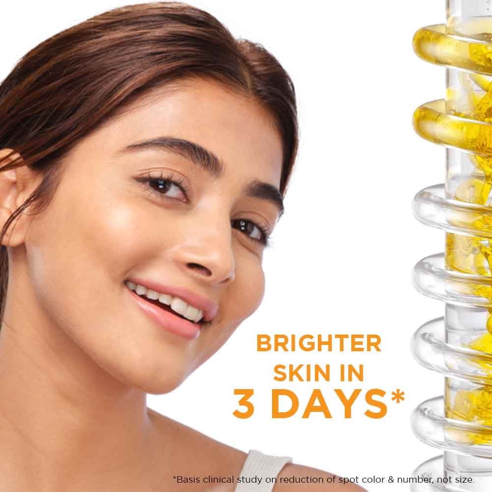 Dropper applying Garnier Vitamin C serum